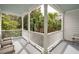 Inviting porch with white railings offering a shady spot to relax and enjoy the surrounding palm trees at 3 Atlantic St, Charleston, SC 29401