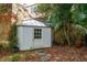 Charming shed with glass roof and door, surrounded by lush greenery and brickwork at 3 Atlantic St, Charleston, SC 29401