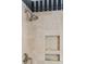 Luxurious shower with travertine tile, rainfall showerhead, built-in niches for storage, and chrome fixtures at 3 Atlantic St, Charleston, SC 29401