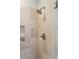 Elegant beige tiled shower featuring a shower head and carved out soap holders in the wall at 3 Atlantic St, Charleston, SC 29401