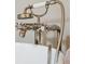 Close up of a sleek chrome faucet with an attached shower head on a white tub at 3 Atlantic St, Charleston, SC 29401