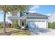 Charming two-story home with gray siding, a well-manicured lawn, and an attached two-car garage at 3016 Adventure Way, Ladson, SC 29456
