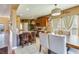 A cozy eat-in kitchen has dark wood cabinets, tile floors, granite countertops, and stainless appliances at 3016 Adventure Way, Ladson, SC 29456