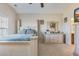 This spacious main bedroom has carpet, an ensuite bathroom, a dresser, a TV, and a large window at 3016 Adventure Way, Ladson, SC 29456