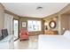 Bright bedroom features a large window, tile flooring, and a cozy striped chair near a sliding door to the balcony at 302 Palmetto Dr # A-302, Isle of Palms, SC 29451