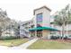 Inviting condo building with lush landscaping and a covered entrance perfect for coastal living at 302 Palmetto Dr # A-302, Isle of Palms, SC 29451