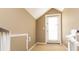 Hallway with beige walls and carpeted floor, features a door leading to the outside and a lift for accessibility at 302 Palmetto Dr # A-302, Isle of Palms, SC 29451