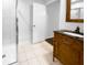 Bright bathroom with white-tiled shower and a vanity with a dark countertop and bamboo-style cabinet at 3048 Queensgate Way, Mount Pleasant, SC 29466