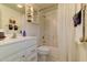 Bright bathroom featuring white fixtures, white tile flooring, and tub with shower at 338 King St # B, Charleston, SC 29401