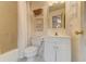 Bright bathroom featuring white fixtures, white tile flooring, and tub with shower at 338 King St # B, Charleston, SC 29401