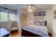 Charming bedroom with a ceiling fan, a window with blinds, and hardwood floors at 338 King St # B, Charleston, SC 29401