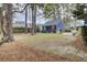 Wide backyard featuring well-maintained lawn, mature trees, and an adjacent blue home at 3409 Southern Cottage Way, Mount Pleasant, SC 29466