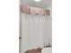 Bathroom featuring a white waffle shower curtain with colorful stripes and pompom trim at 3409 Southern Cottage Way, Mount Pleasant, SC 29466