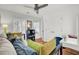 Bright bedroom featuring a ceiling fan, built-in shelving, closet and a comfortable sofa at 3409 Southern Cottage Way, Mount Pleasant, SC 29466