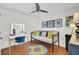 Bright bedroom featuring a vanity desk, sofa, and cheerful decor at 3409 Southern Cottage Way, Mount Pleasant, SC 29466