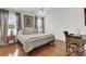 Bright bedroom featuring hardwood floors, a comfortable bed, and a small vanity at 3409 Southern Cottage Way, Mount Pleasant, SC 29466