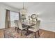 Elegant dining room with hardwood floors, chandelier, and a large window for natural light at 3409 Southern Cottage Way, Mount Pleasant, SC 29466