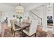 Spacious dining room features hardwood floors, decorative rug, and staircase access at 3409 Southern Cottage Way, Mount Pleasant, SC 29466