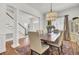 Dining room with a large table, chandelier, and adjacent stairs to the second floor at 3409 Southern Cottage Way, Mount Pleasant, SC 29466