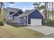 Charming blue two-story home with attached garage and fenced yard at 3409 Southern Cottage Way, Mount Pleasant, SC 29466