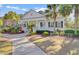Exterior of the fitness center featuring white columns and a welcoming entrance with palm trees around the building at 3409 Southern Cottage Way, Mount Pleasant, SC 29466