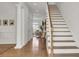 Elegant foyer with hardwood floors, staircase, and views into the living area at 3409 Southern Cottage Way, Mount Pleasant, SC 29466