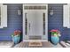 Beautiful entryway with a white door, sidelights, and plants in decorative pots at 3409 Southern Cottage Way, Mount Pleasant, SC 29466