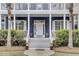 Inviting front door with white trim, potted flowers, and steps leading up to the entrance at 3409 Southern Cottage Way, Mount Pleasant, SC 29466