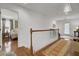 Upstairs hallway with wood floors, white walls, and views of the bedroom and sitting area at 3409 Southern Cottage Way, Mount Pleasant, SC 29466