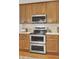 Modern kitchen boasts stainless steel appliances, double oven, and beautiful wooden cabinets at 3409 Southern Cottage Way, Mount Pleasant, SC 29466