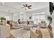 Bright and airy living room with plush seating, ceiling fan, and large windows at 3409 Southern Cottage Way, Mount Pleasant, SC 29466