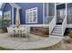 Outdoor dining area featuring a stone patio, dining table, umbrella, and adjacent stairway at 3409 Southern Cottage Way, Mount Pleasant, SC 29466