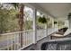 Covered porch featuring wicker seating and views of the street and neighborhood at 3409 Southern Cottage Way, Mount Pleasant, SC 29466