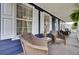 Charming front porch with wicker seating and blue wood facade at 3409 Southern Cottage Way, Mount Pleasant, SC 29466