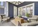 Relaxing screened porch with comfortable seating, overhead fan, and views of the backyard at 3409 Southern Cottage Way, Mount Pleasant, SC 29466