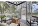 Relaxing screened porch with comfortable seating, overhead fan, and serene views of the surrounding trees at 3409 Southern Cottage Way, Mount Pleasant, SC 29466