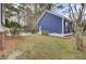 Side yard view showing the home's blue siding, landscaping, and manicured lawn at 3409 Southern Cottage Way, Mount Pleasant, SC 29466