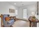 Cozy sitting area with comfortable blue chair, rug, and natural light from windows and door at 3409 Southern Cottage Way, Mount Pleasant, SC 29466