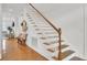 Classic staircase with wooden treads, white risers, and a wood railing at 3409 Southern Cottage Way, Mount Pleasant, SC 29466