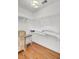 Bright walk-in closet with white wire shelving and hardwood floors at 3409 Southern Cottage Way, Mount Pleasant, SC 29466