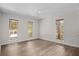 A bedroom with three windows, vinyl floors, and a ceiling fan at 3475 Deer Run Rd, Seabrook Island, SC 29455