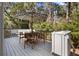 Outdoor deck with a table, chairs, bench, umbrella, and surrounding foliage at 3475 Deer Run Rd, Seabrook Island, SC 29455