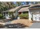 Close up of a beautiful home with neutral siding and a bright red front door at 3475 Deer Run Rd, Seabrook Island, SC 29455