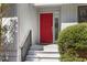 A bright red front door with sidelight and black hardware at 3475 Deer Run Rd, Seabrook Island, SC 29455