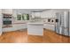 Modern kitchen with white cabinets, stainless steel appliances, and center island at 3475 Deer Run Rd, Seabrook Island, SC 29455
