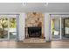 Cozy living room featuring a stone fireplace and sliding glass doors to an outdoor deck at 3475 Deer Run Rd, Seabrook Island, SC 29455