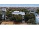 Stunning beach house surrounded by lush trees, with a glimpse of the ocean at 3803 Palm Blvd, Isle of Palms, SC 29451