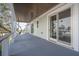 Inviting covered balcony with ample natural light and stylish railings at 3803 Palm Blvd, Isle of Palms, SC 29451