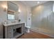 Bathroom with stone countertops, drawers below the sink, and a glass-enclosed shower at 3803 Palm Blvd, Isle of Palms, SC 29451