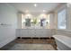 Bathroom featuring dual vanities with marble countertop and a soaking tub on the right at 3803 Palm Blvd, Isle of Palms, SC 29451